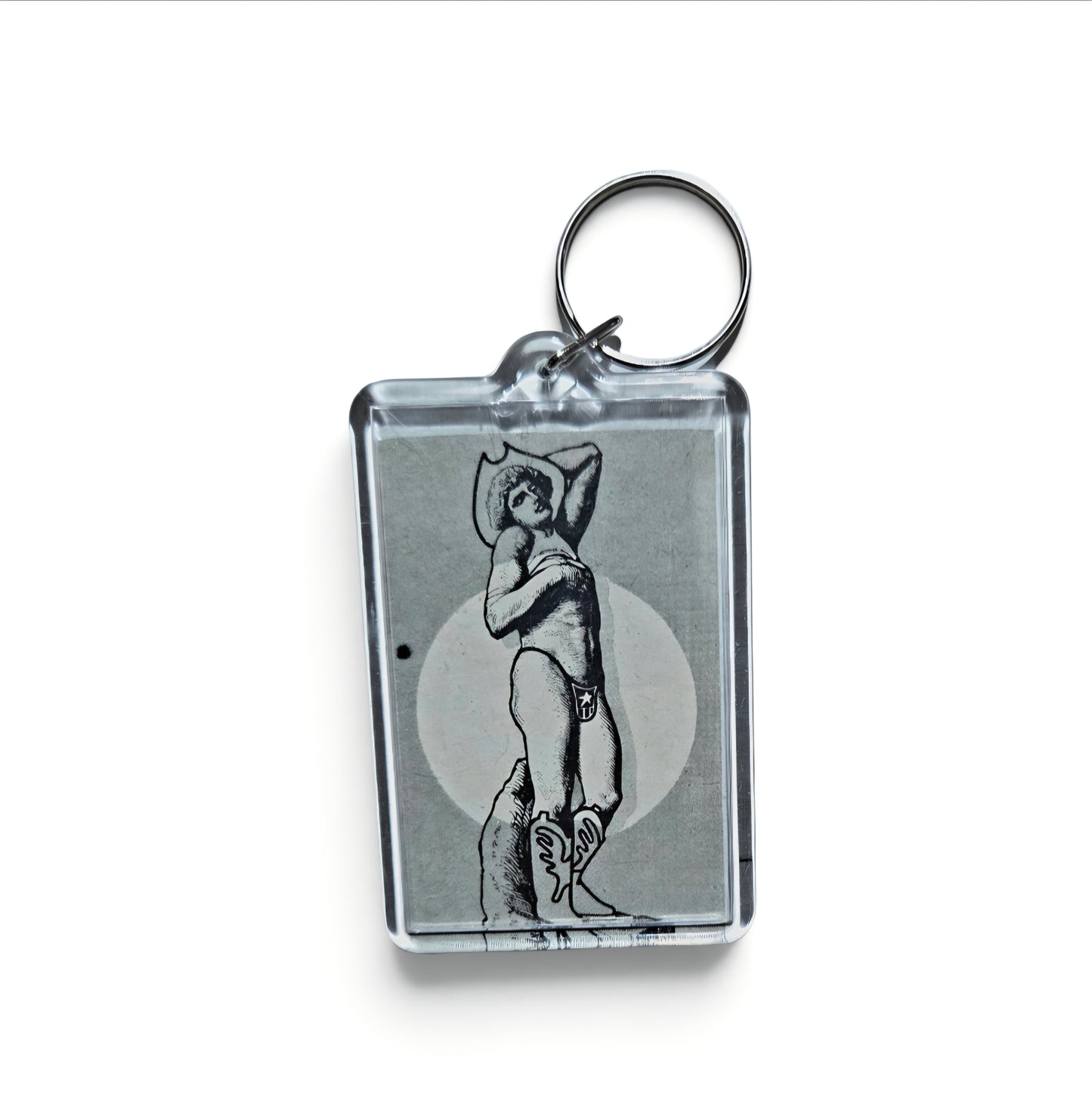 Keychain featuring a black-and-line illustration of a stylized cowboy