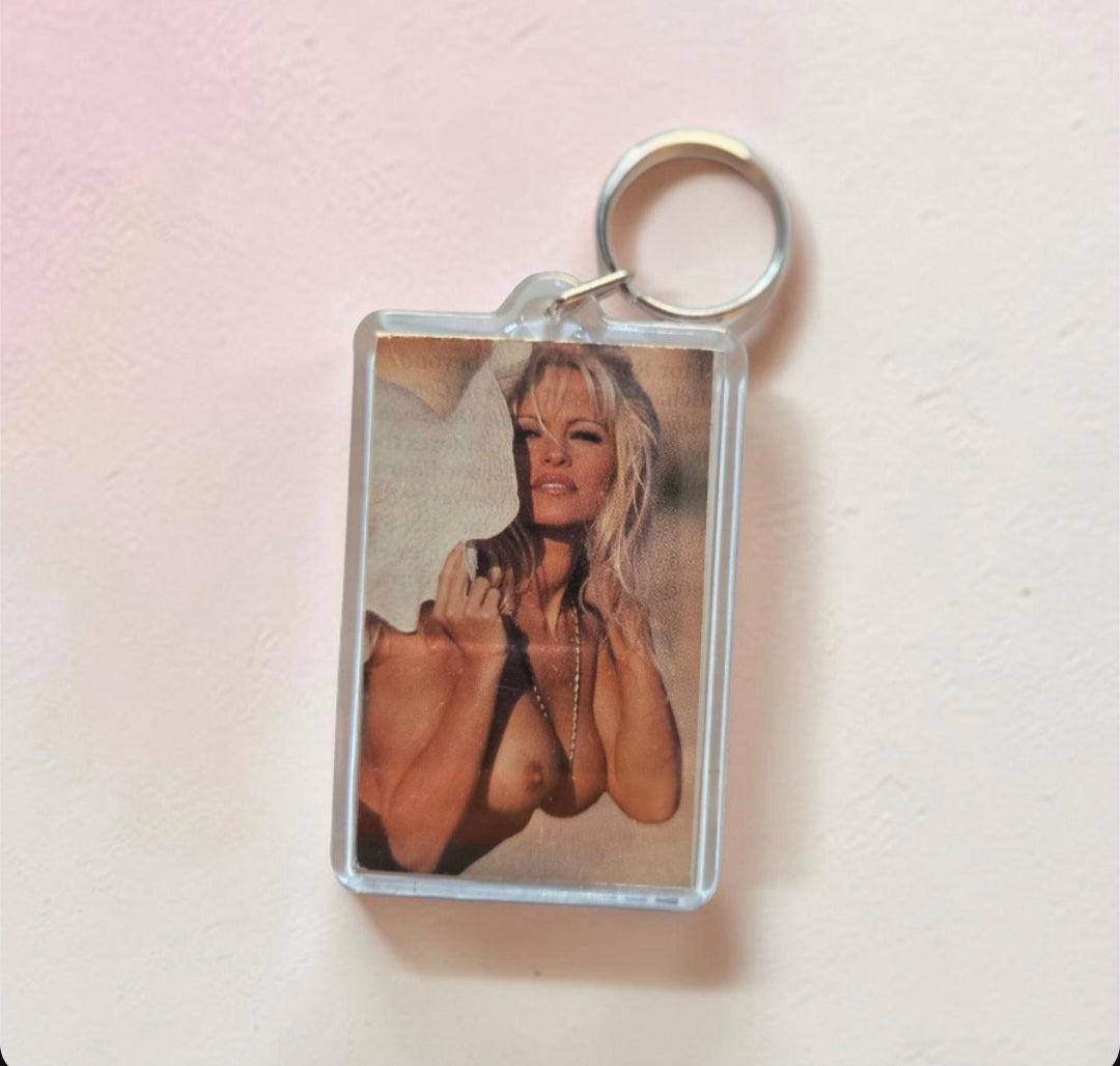 Novelty keychain featuring a vintage-style portrait insert that resembles actress and model Pamela Anderson