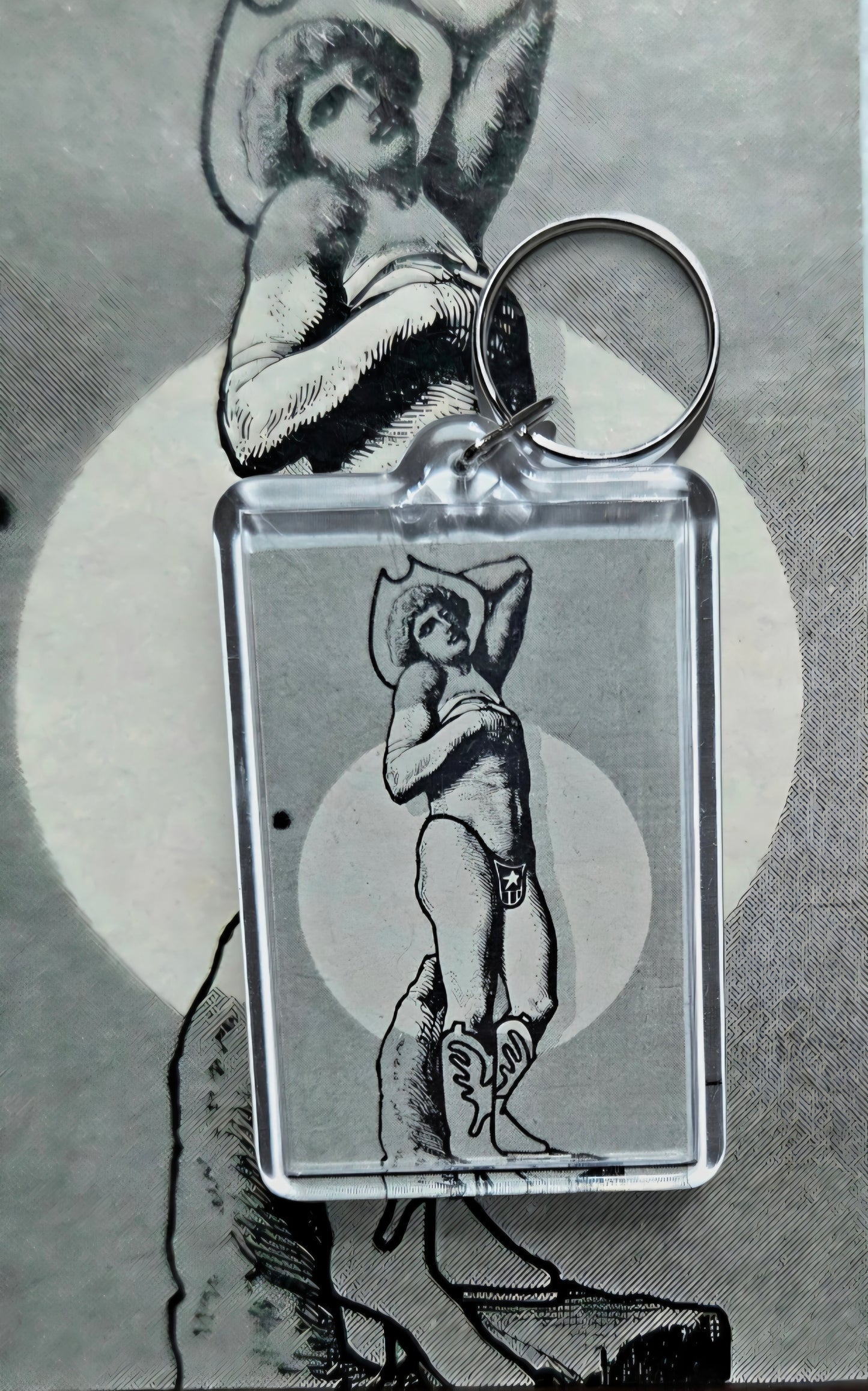 Keychain featuring a black-and-line illustration of a stylized cowboy